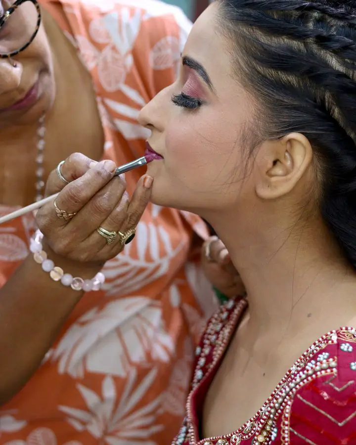 Finishing touches to a bride’s lipstick
