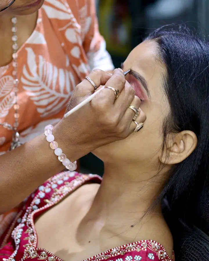 Makeup artist working on a bride’s eyes