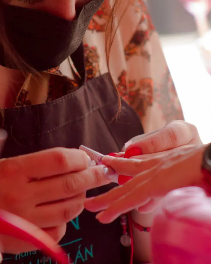 Nail technician building nail extensions