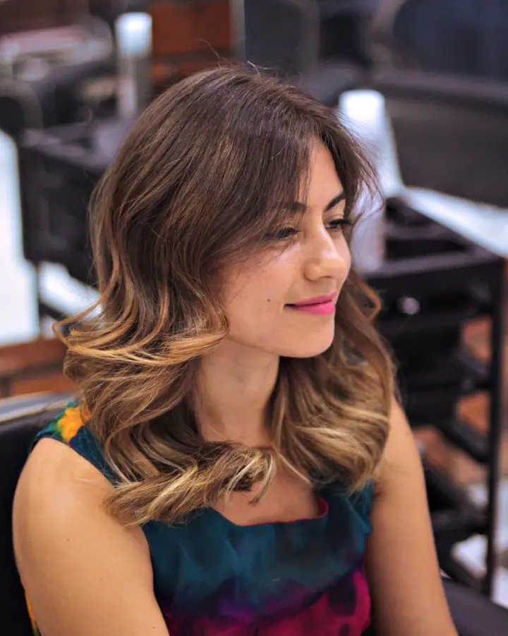 Client with curly ombré hair sitting in the salon