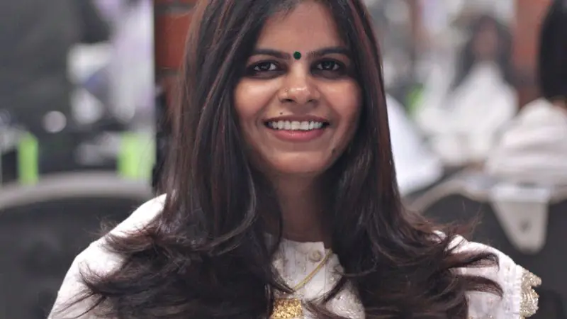 Client smiling in the salon chair after a layered cut
