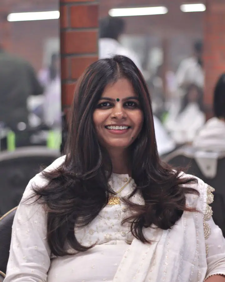 Client smiling in the salon chair after a layered cut
