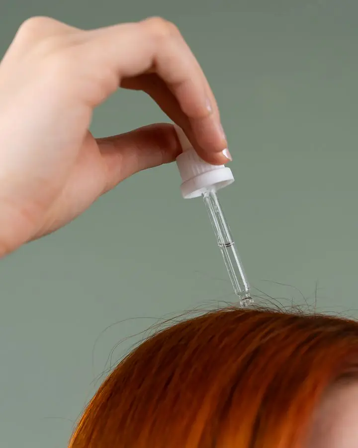 Hair serum being applied from a dropper